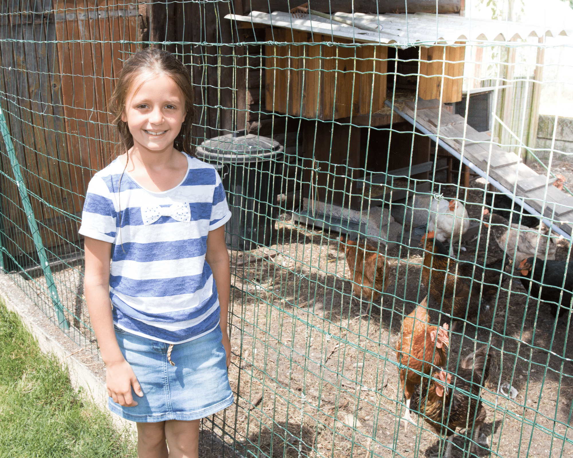 girl standing next to backyard chicken coop