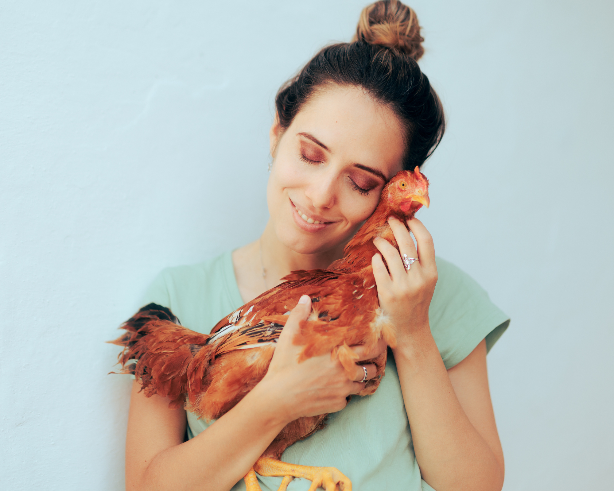 woman bonding with pet chicken